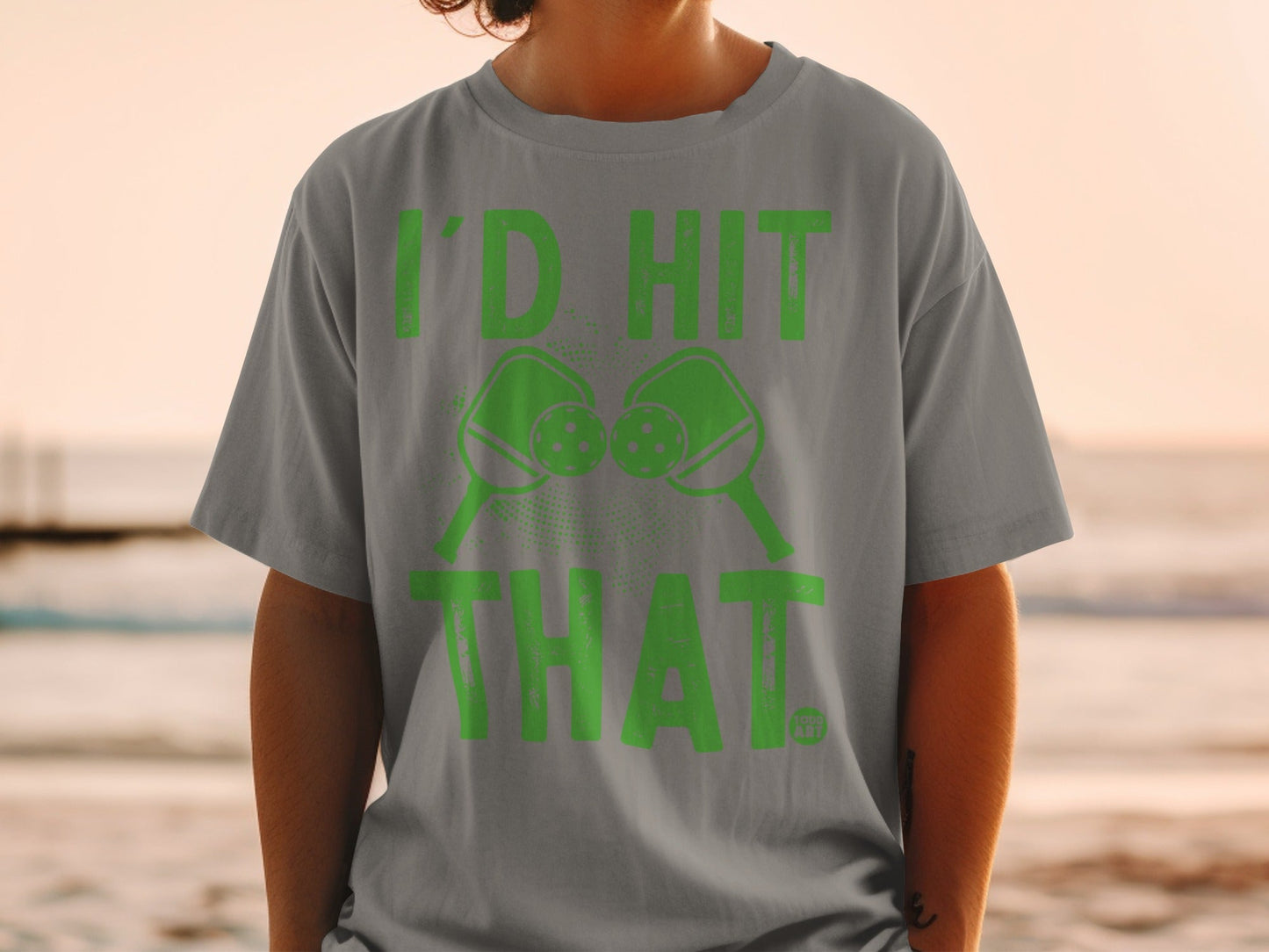Green graphic t-shirt with pickleball paddles and text that reads "I'D HIT THAT."