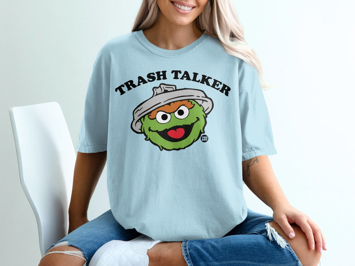 Light blue t-shirt with Oscar the Grouch saying "Trash Talker."