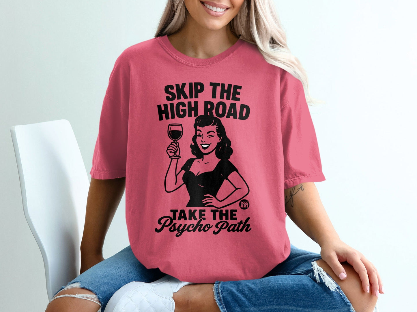 Pink t-shirt with "Skip the high road, take the psycho path" graphic.