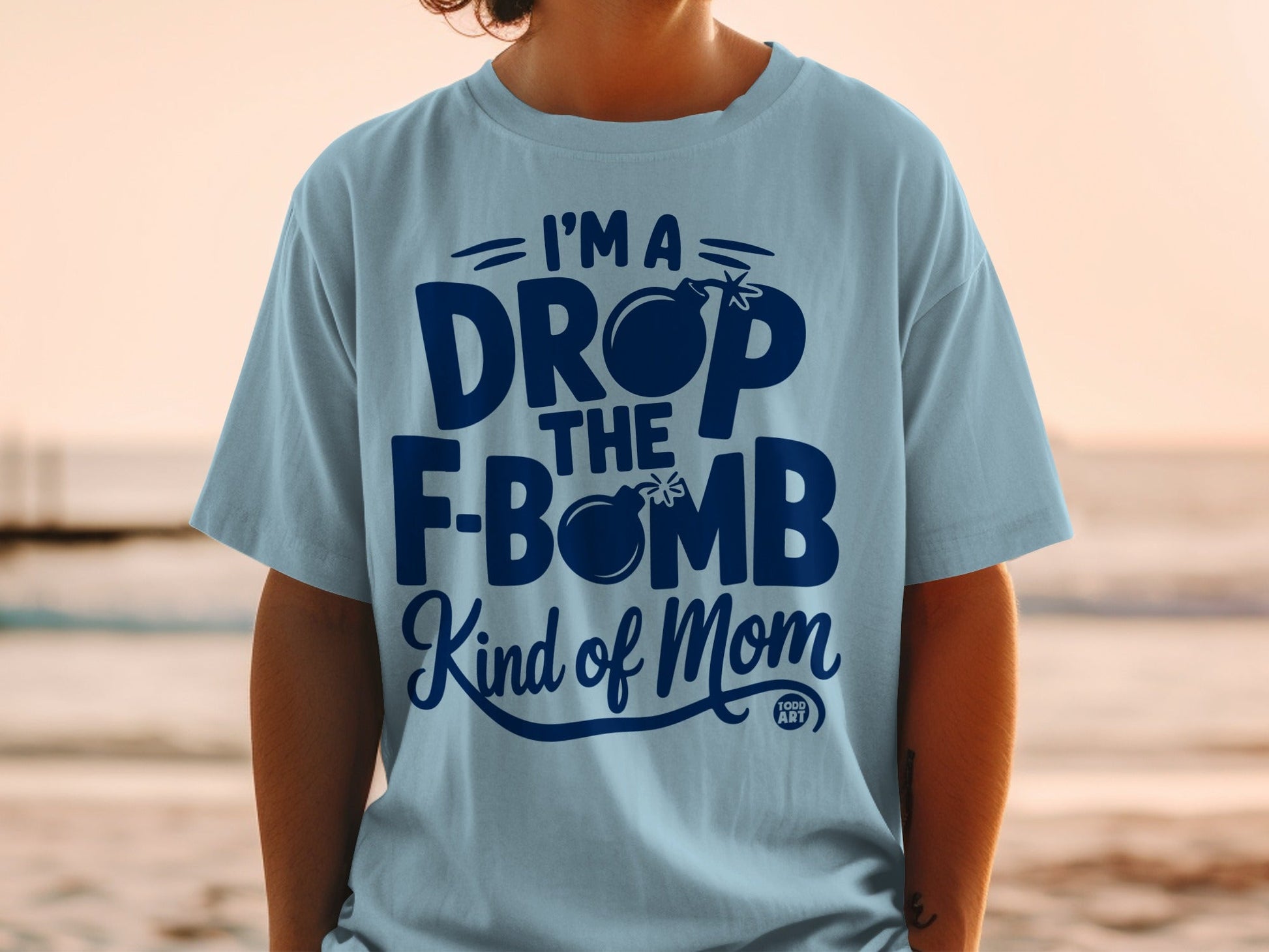 Light blue t-shirt with dark blue text and a bomb graphic.