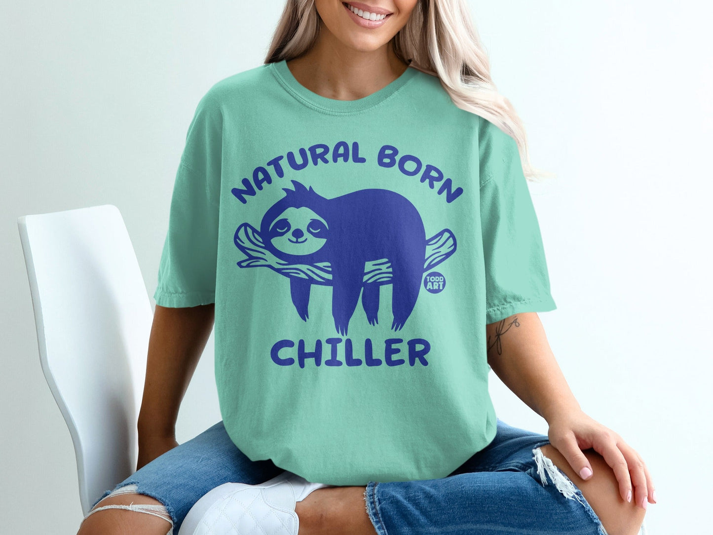 Teal t-shirt with a purple sloth graphic and "NATURAL BORN CHILLER" text.