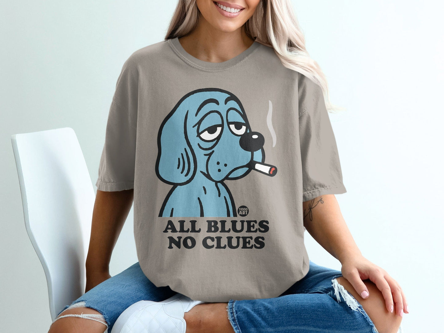 Blue cartoon dog with cigarette on t-shirt, text "ALL BLUES NO CLUES".