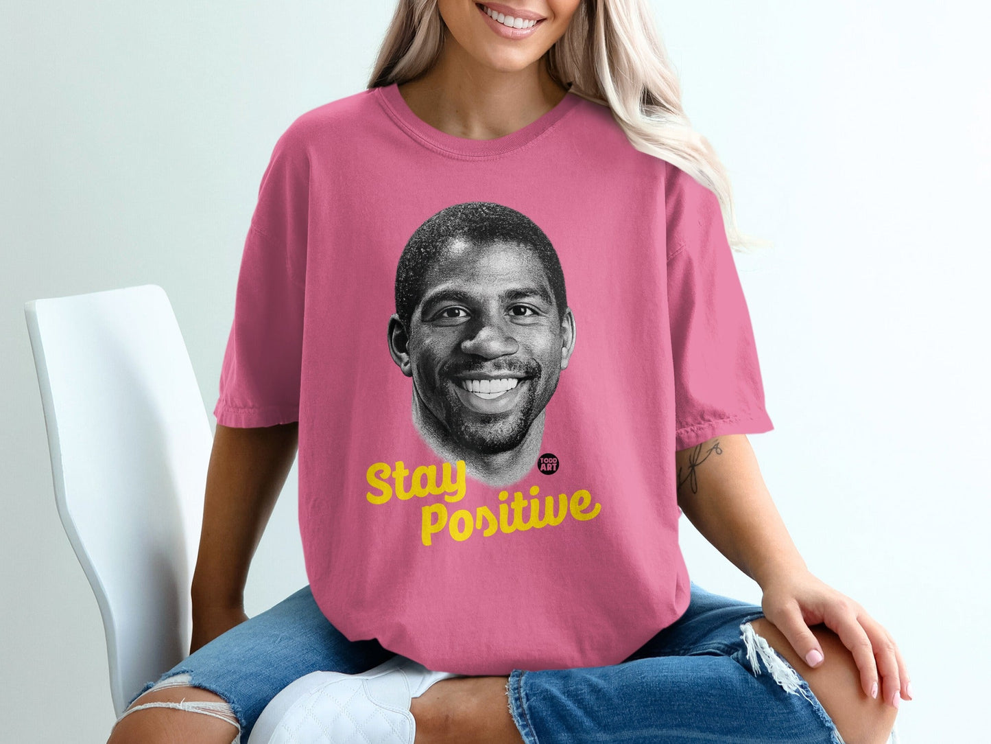Pink t-shirt with Magic Johnson's portrait and "Stay Positive" text.