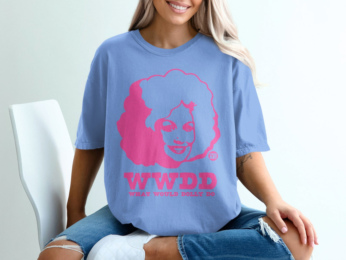 Blue t-shirt with pink graphic of woman and "WWDD" text.