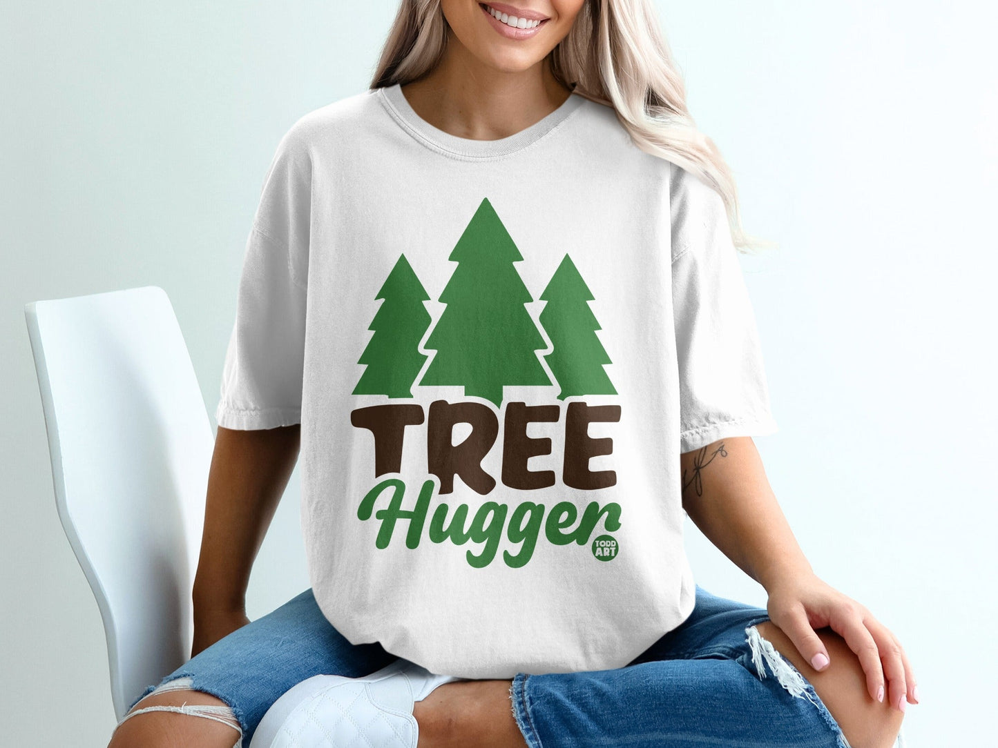 White t-shirt with green trees and "TREE Hugger" text.