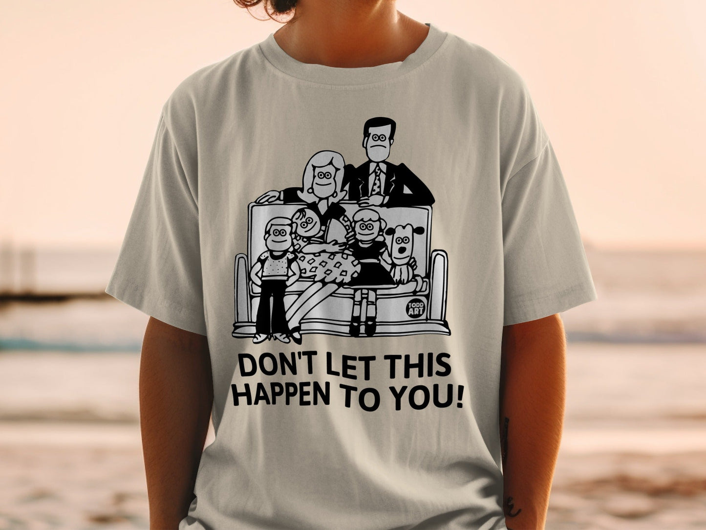 T-shirt with cartoon family on couch and text "DON'T LET THIS HAPPEN TO YOU!"