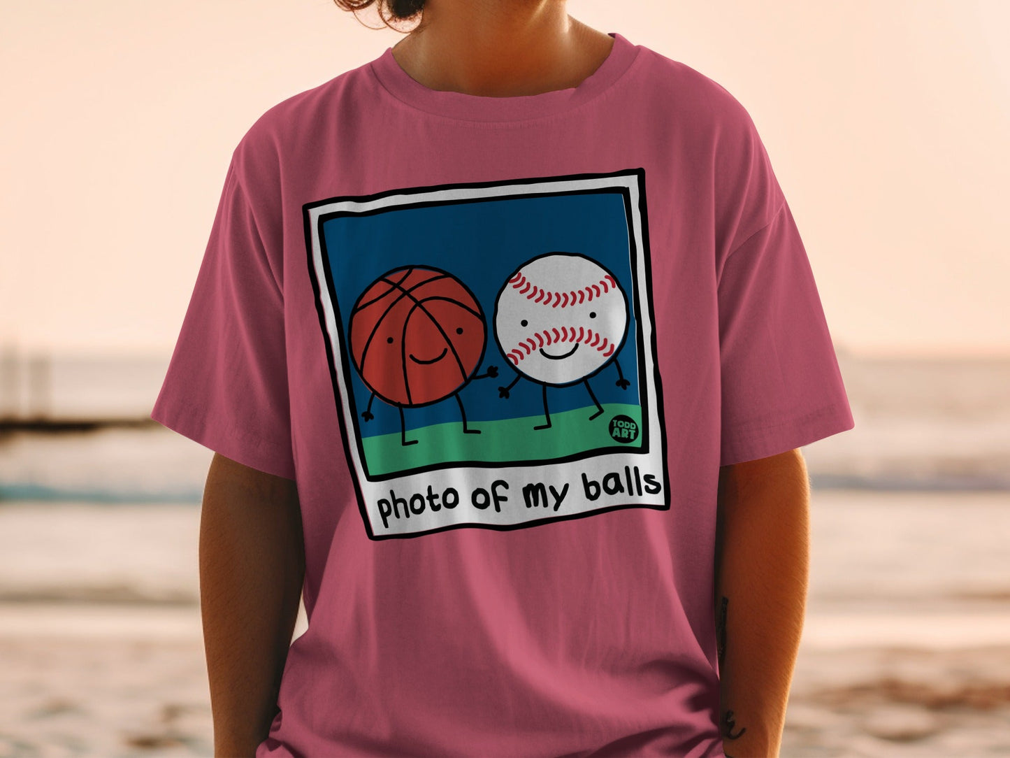 T-shirt with cartoon basketball and baseball holding hands, text "photo of my balls".