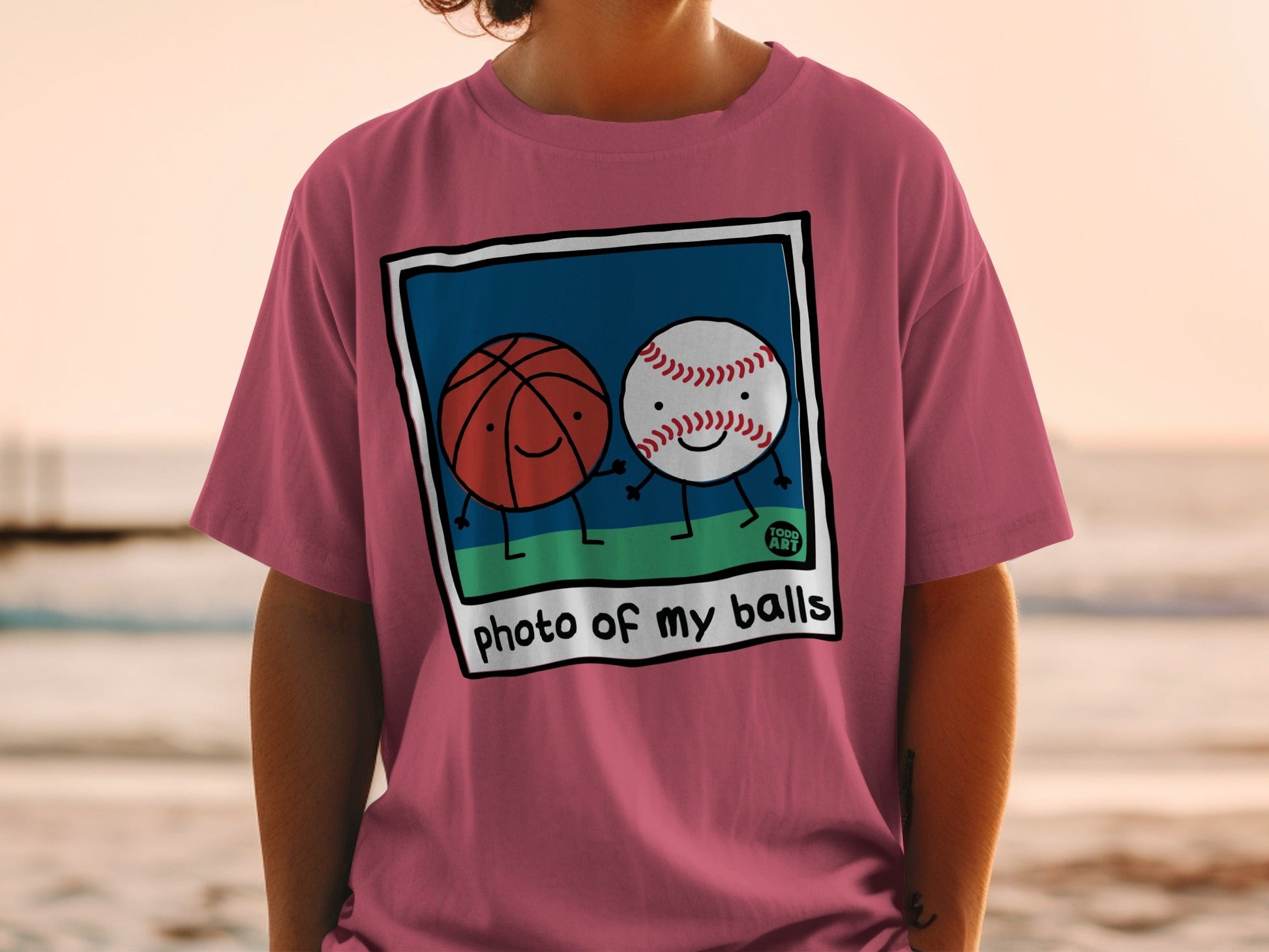 T-shirt with cartoon basketball and baseball holding hands, text "photo of my balls".