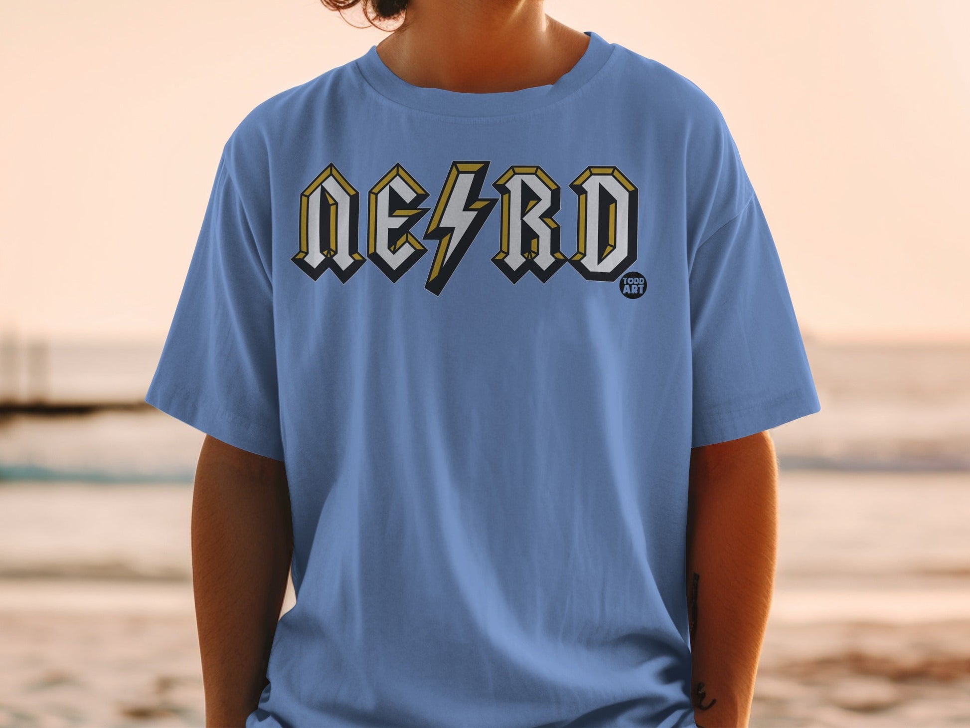 Blue t-shirt with "NERD" in lightning bolt style font and "100D ART" logo.