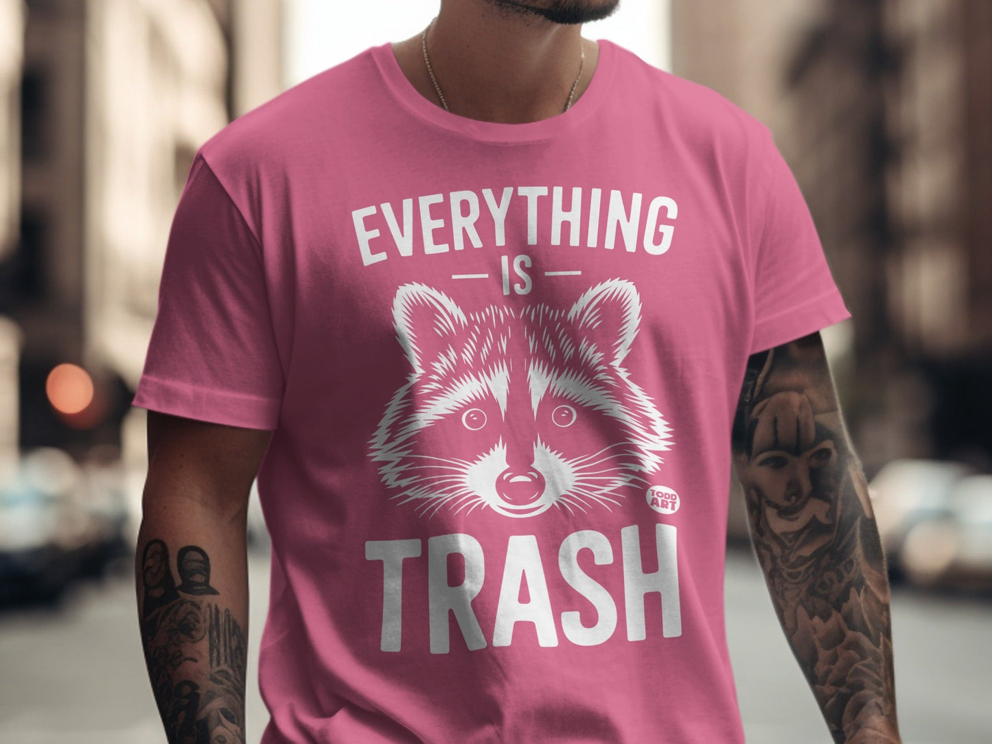 Pink t-shirt with raccoon graphic and "EVERYTHING IS TRASH" text.