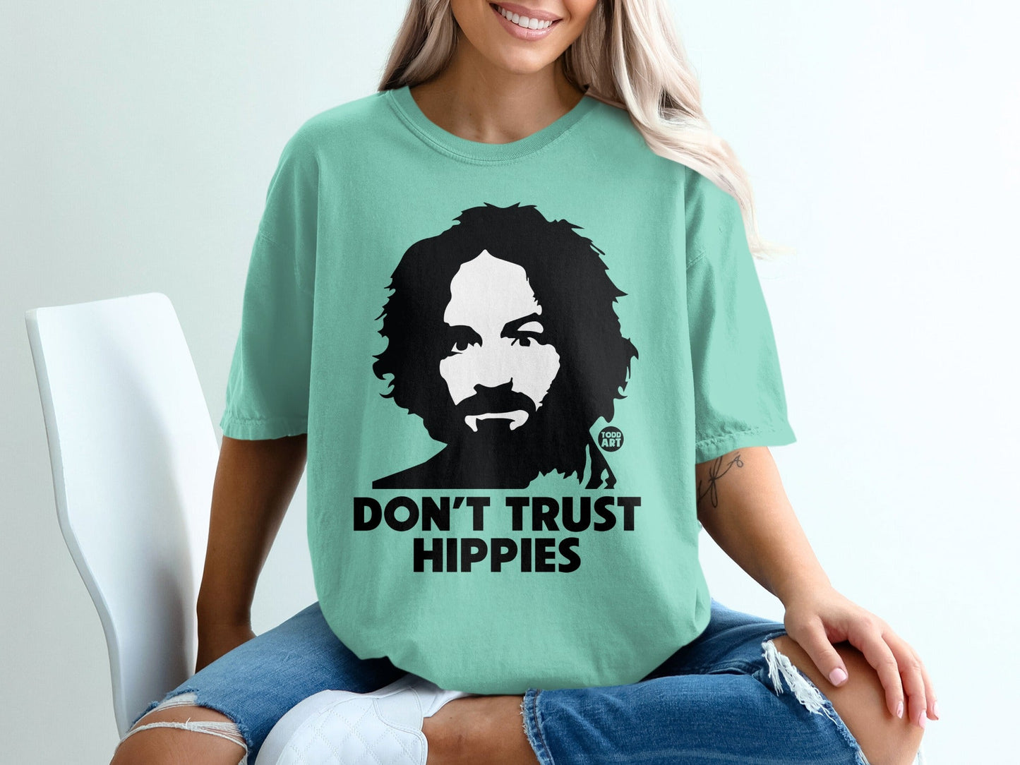 Mint t-shirt with Charles Manson graphic and text "Don't Trust Hippies."