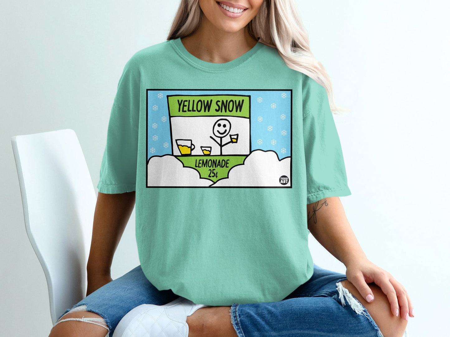 T-shirt with cartoon of lemonade stand selling "Yellow Snow" for 25 cents.