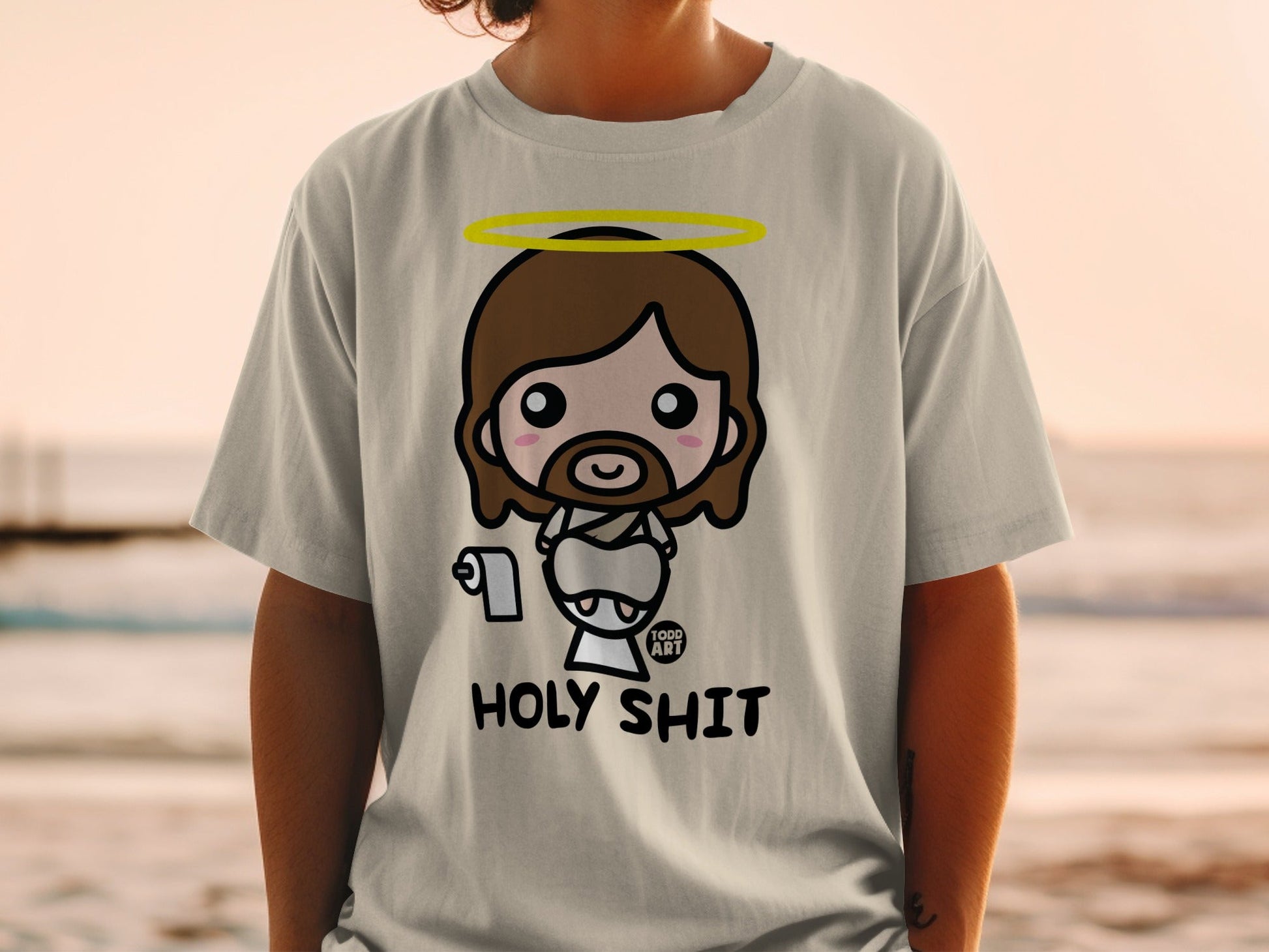 Cute cartoon Jesus with halo on t-shirt, text reads "HOLY SHIT".