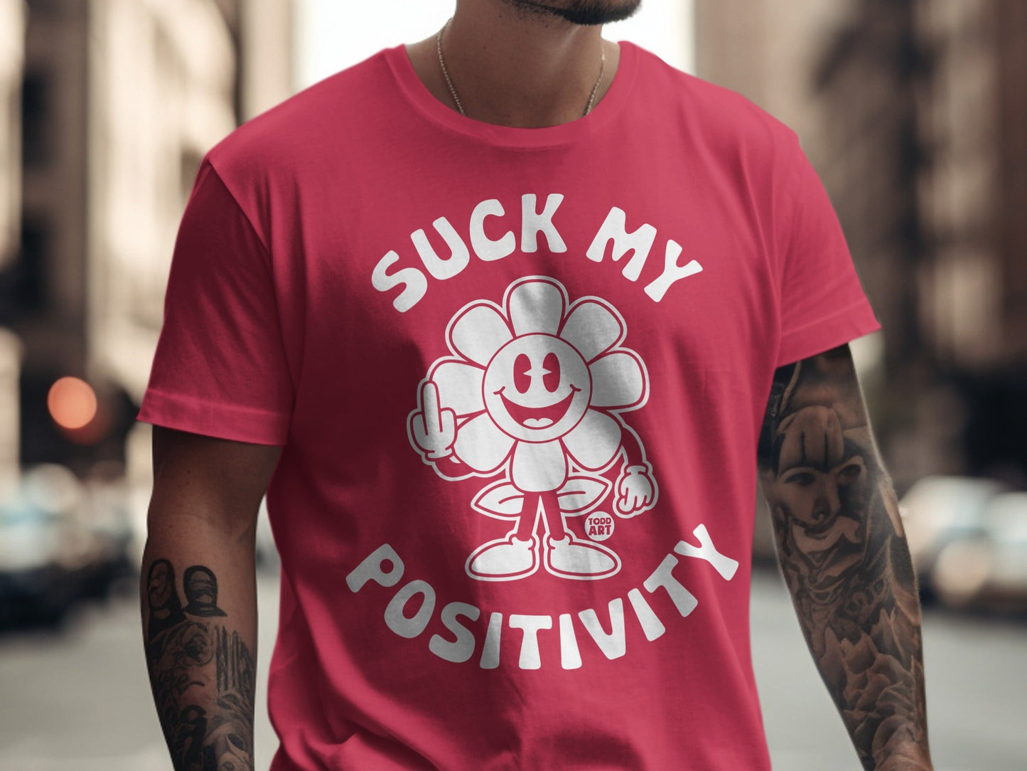 Red t-shirt with cartoon flower giving middle finger and text "SUCK MY POSITIVITY".