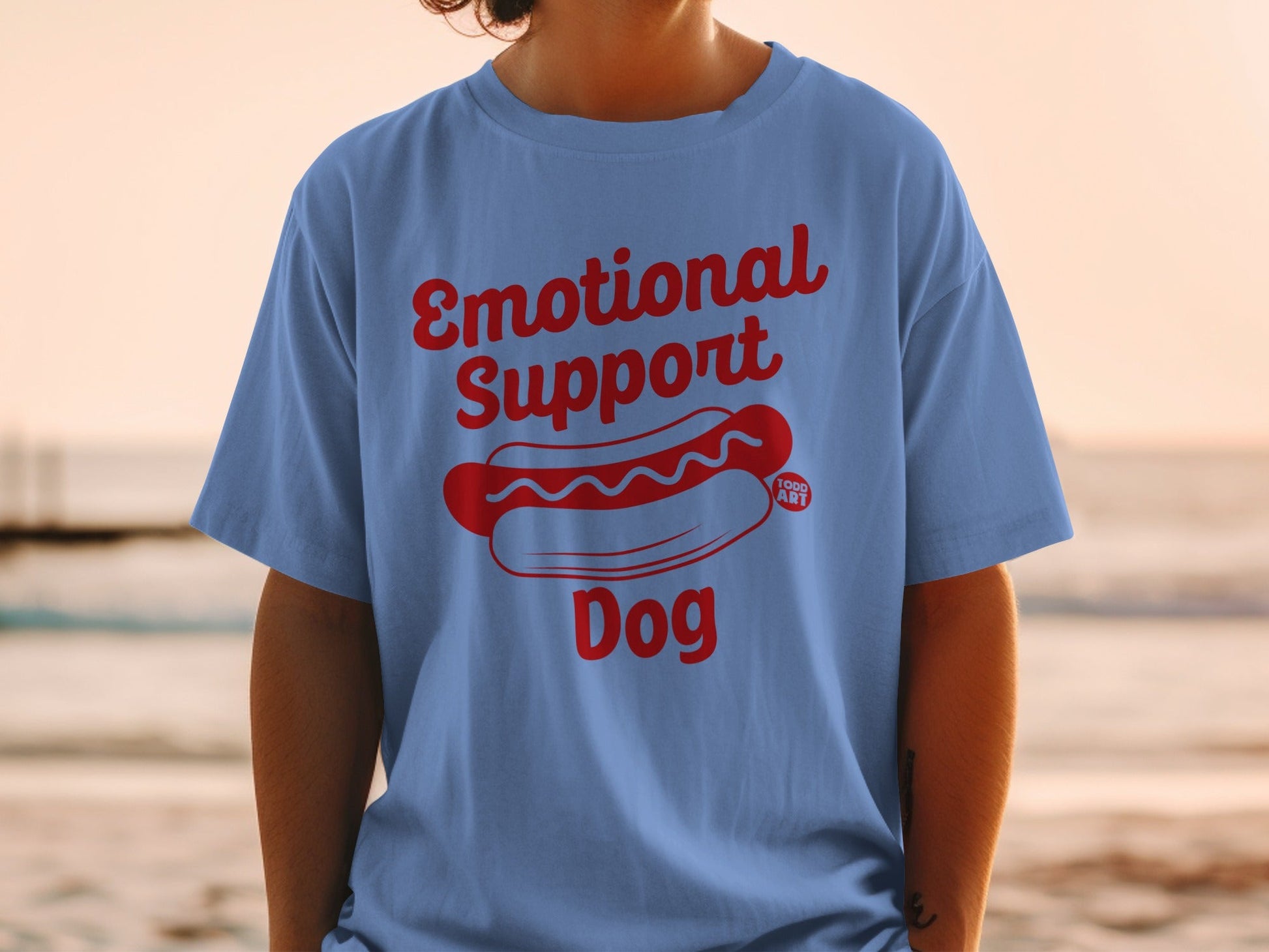 Blue t-shirt with red "Emotional Support Dog" text and hot dog graphic.
