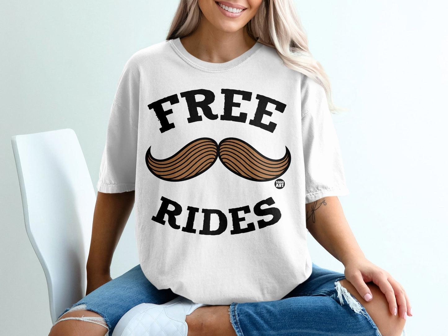 White t-shirt with "FREE RIDES" and a mustache graphic.