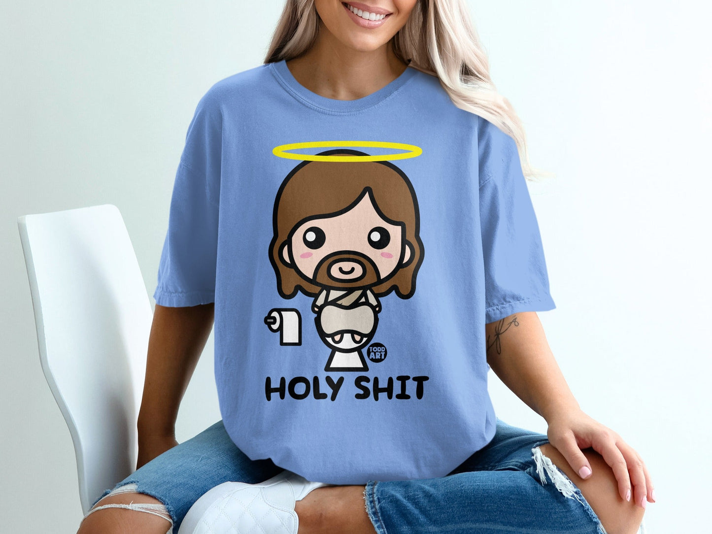 Chibi Jesus character in blue t-shirt with "HOLY SHIT" text, holding toilet paper.
