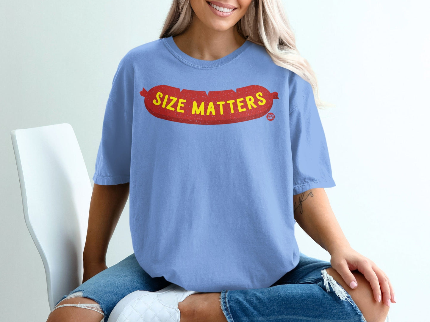 Light blue t-shirt with red "Size Matters" text in a sausage shape.