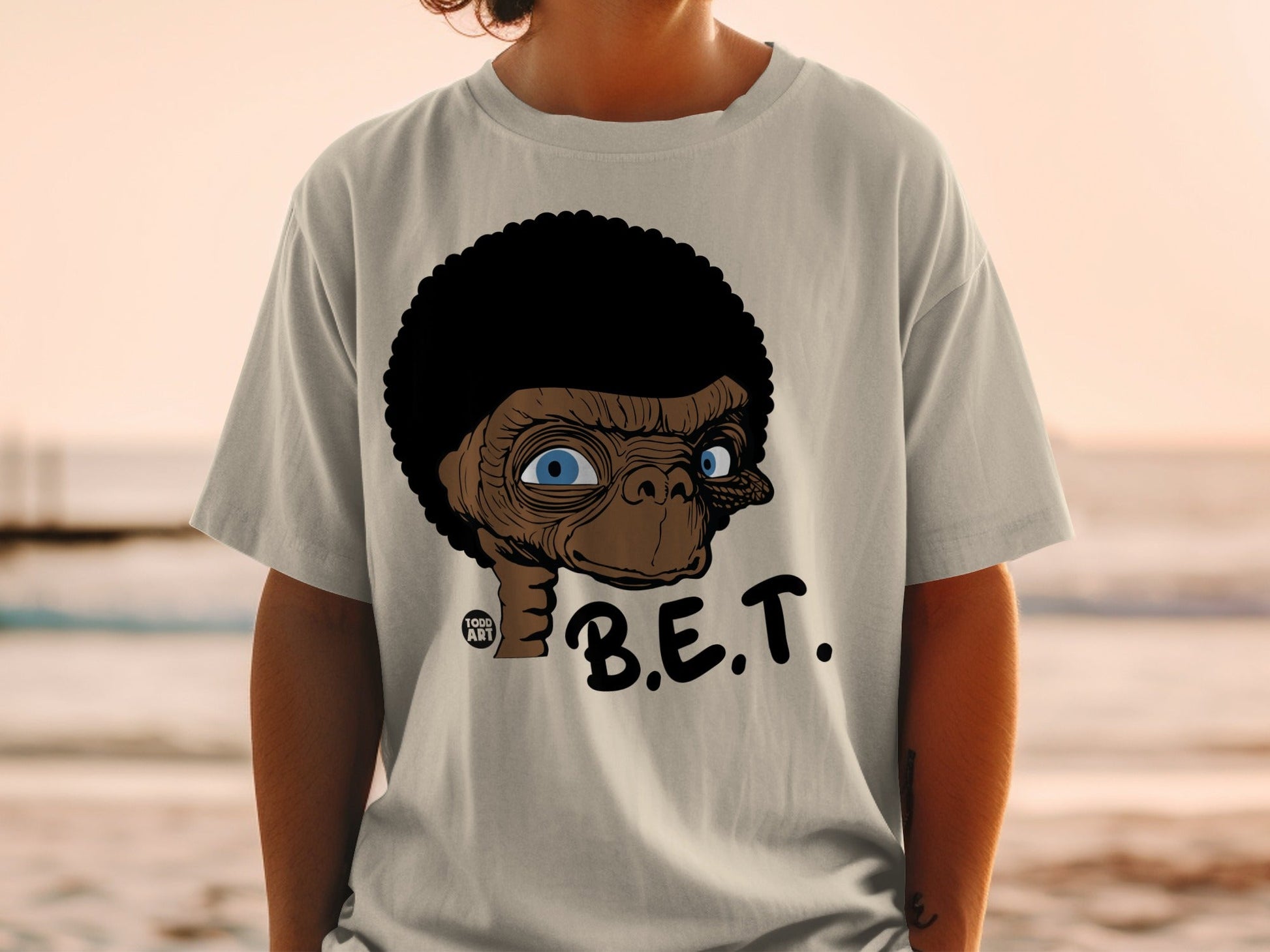 T-shirt with cartoon E.T. face and "B.E.T." text.