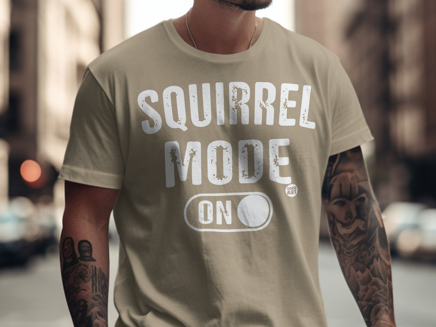Tan t-shirt with "SQUIRREL MODE ON" text and a toggle switch.