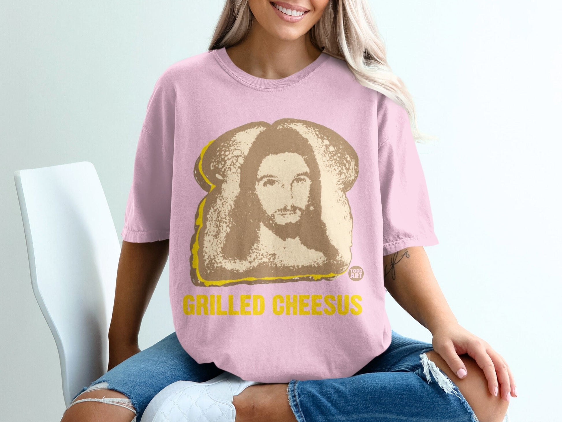 Pink t-shirt with "GRILLED CHEESUS" and Jesus graphic.