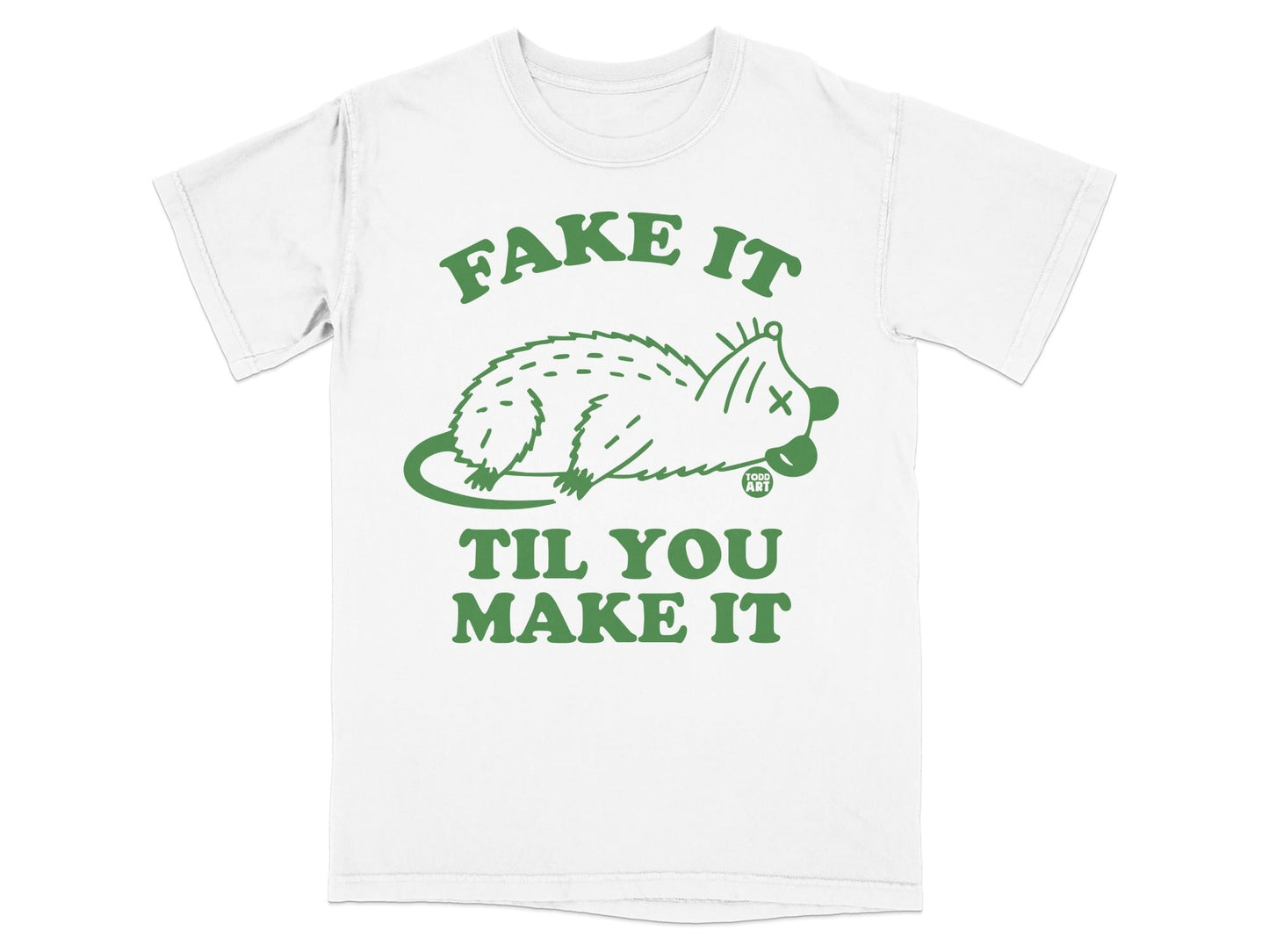 White t-shirt with green "Fake It Til You Make It" text and a stylized possum graphic.