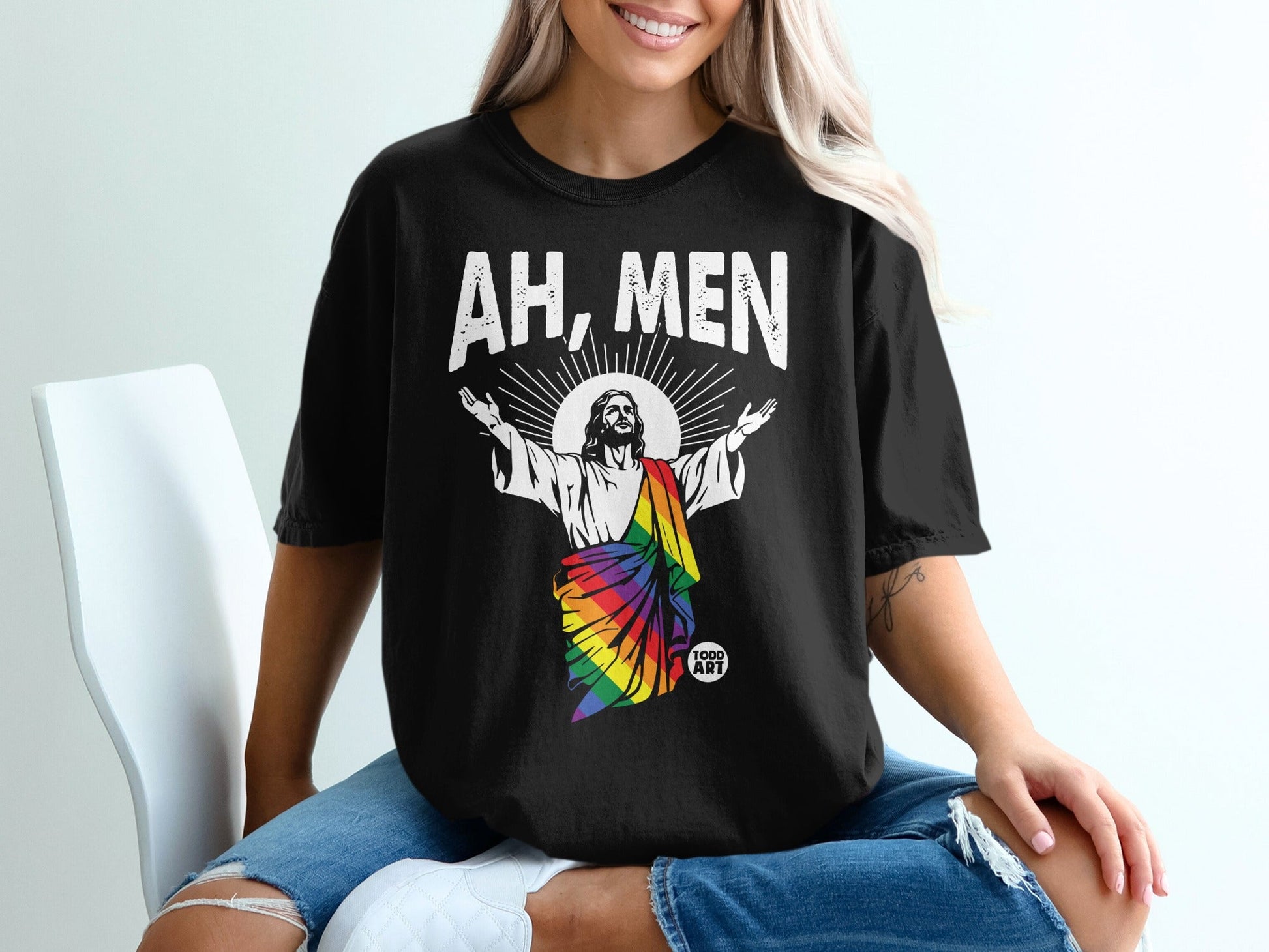 Black t-shirt with Jesus in a rainbow robe, text "AH, MEN" above.