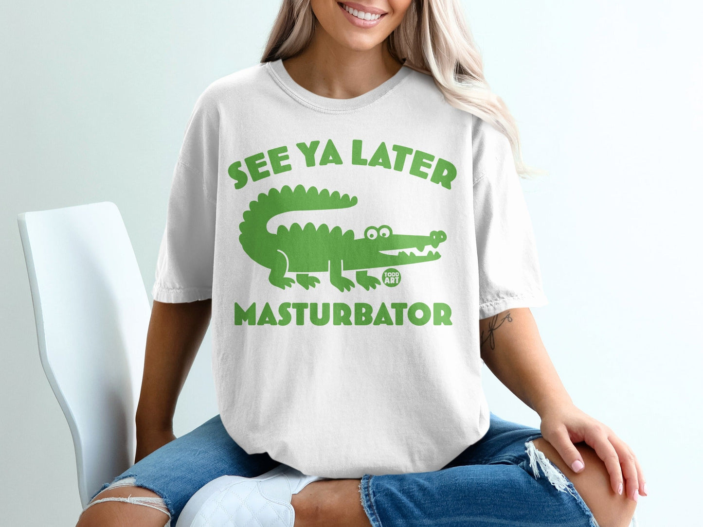 White t-shirt with green alligator and "SEE YA LATER MASTURBATOR" text.