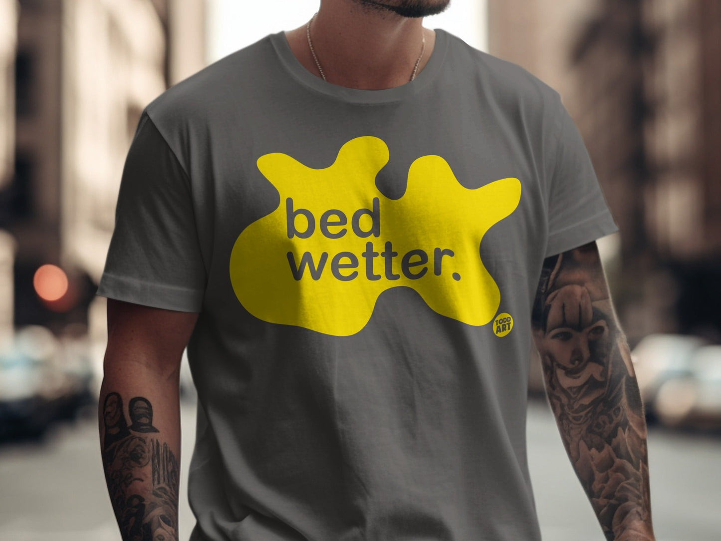 Dark grey t-shirt with yellow "bed wetter" graphic and "TOOD ART" logo.