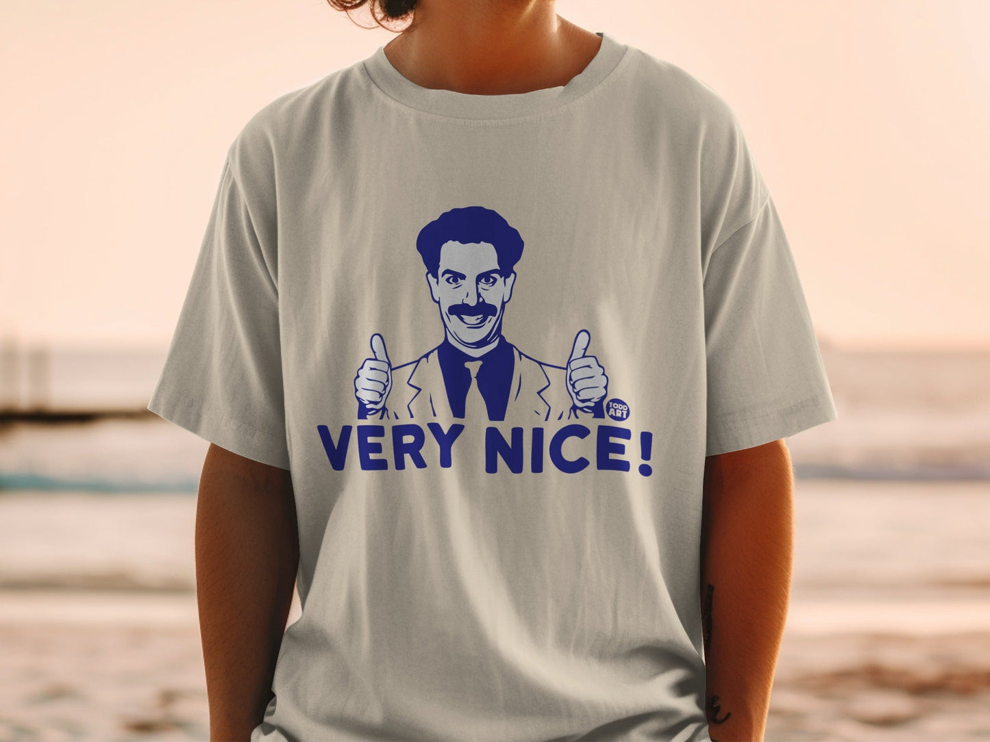 T-shirt with cartoon man giving two thumbs up and "Very Nice!" text.