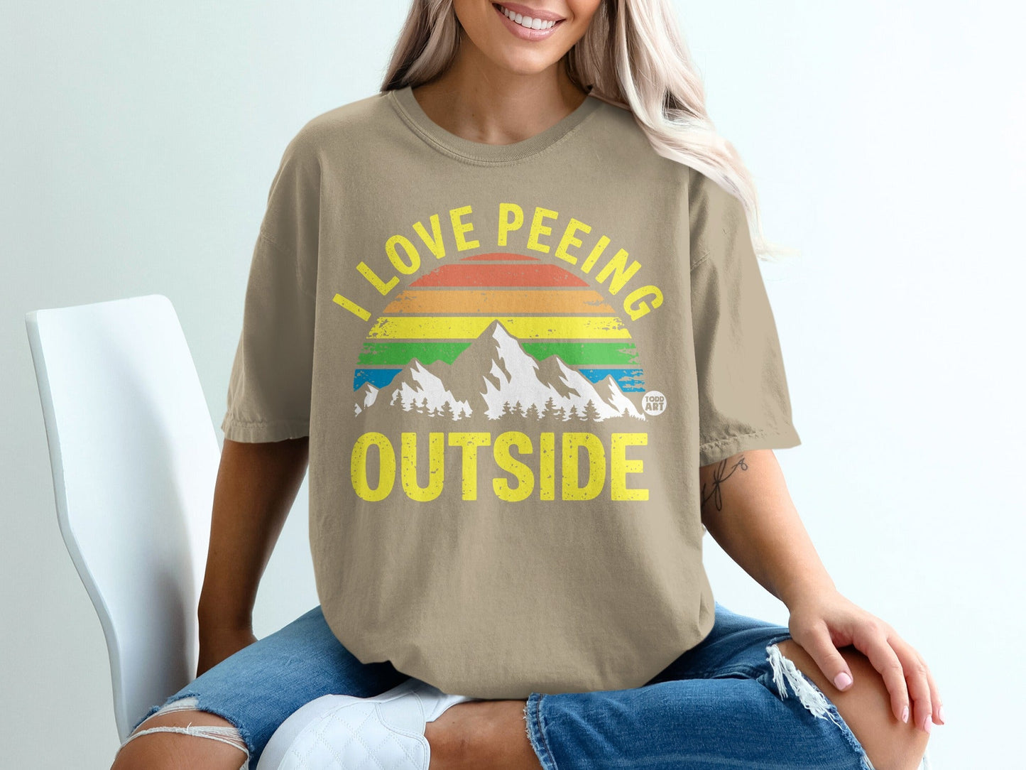 T-shirt with "I Love Peeing Outside" and rainbow mountain graphic.