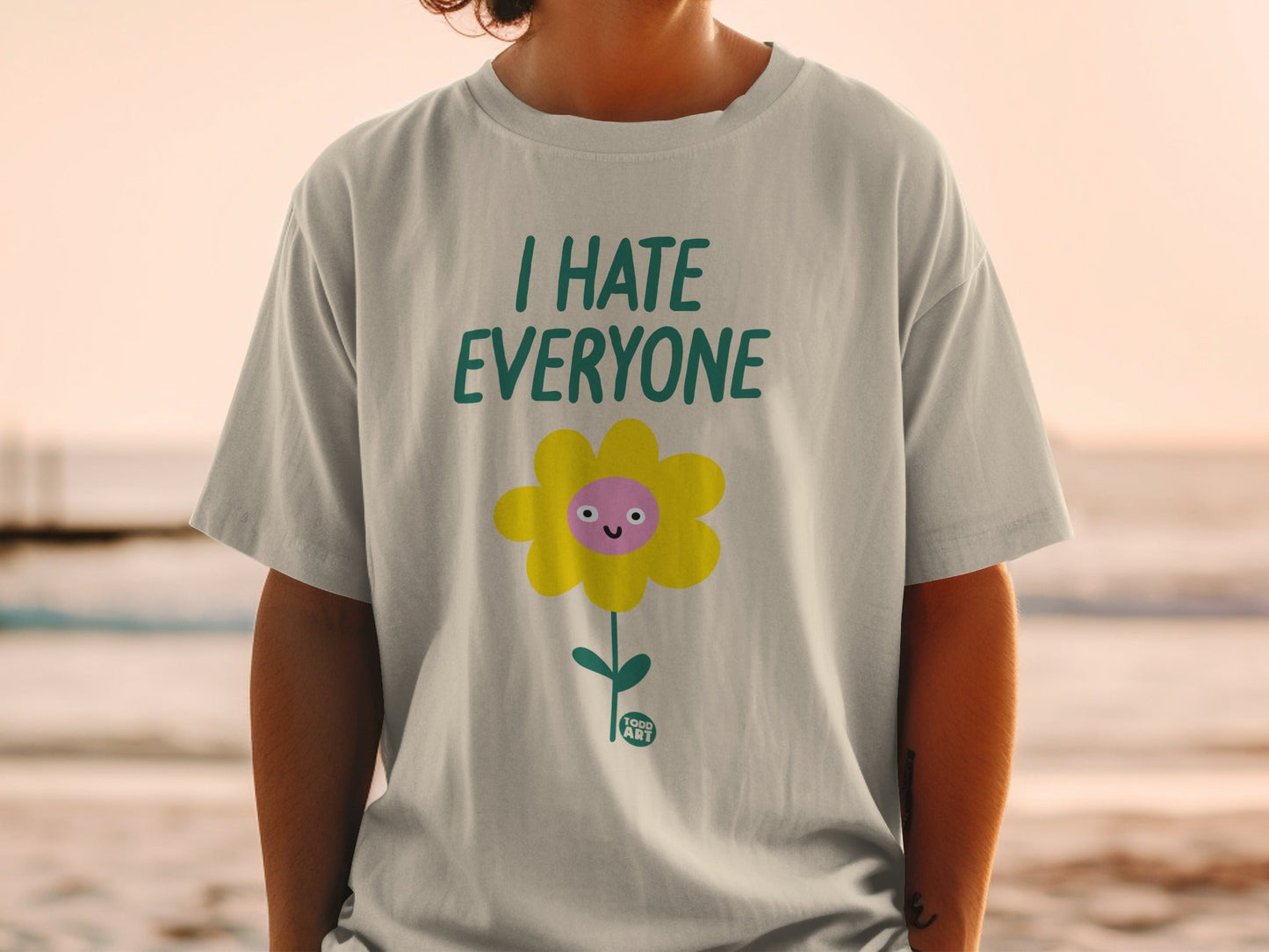 T-shirt with a yellow flower graphic that says "I HATE EVERYONE".